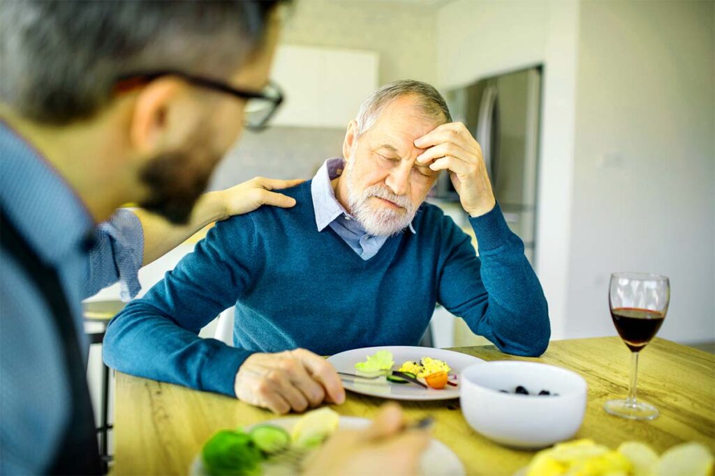 man having pain while eating